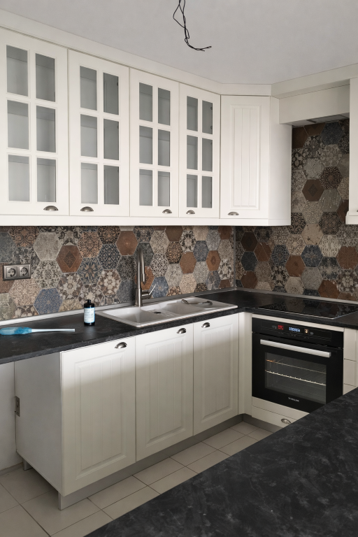 Remodeled kitchen with shaker cabinets and marble countertop