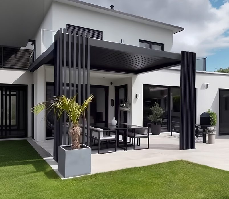 Louvered pergola matched to a home's rooflines and stone